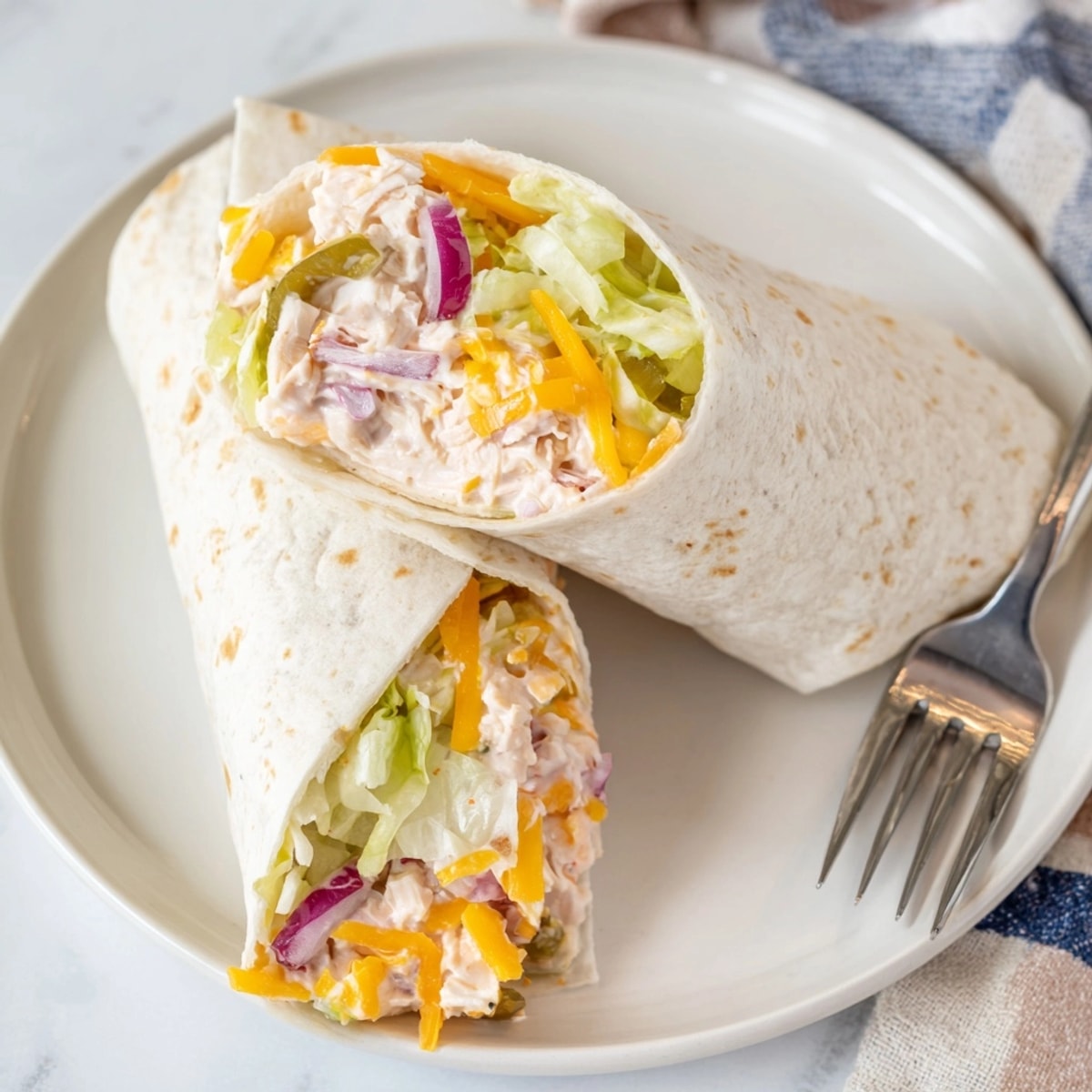 Golden Ranch Pickle Chicken Melt Wraps sizzle melty cheese in the skillet, ready to serve.