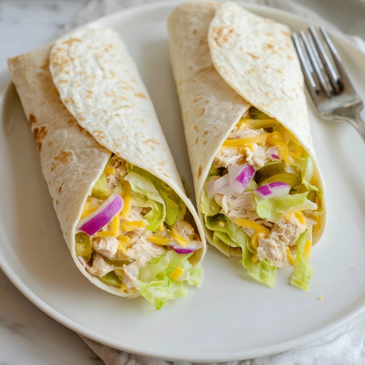 Tangy Ranch Pickle Chicken Melt Wrap: warm tortilla with diced pickles and creamy chicken.