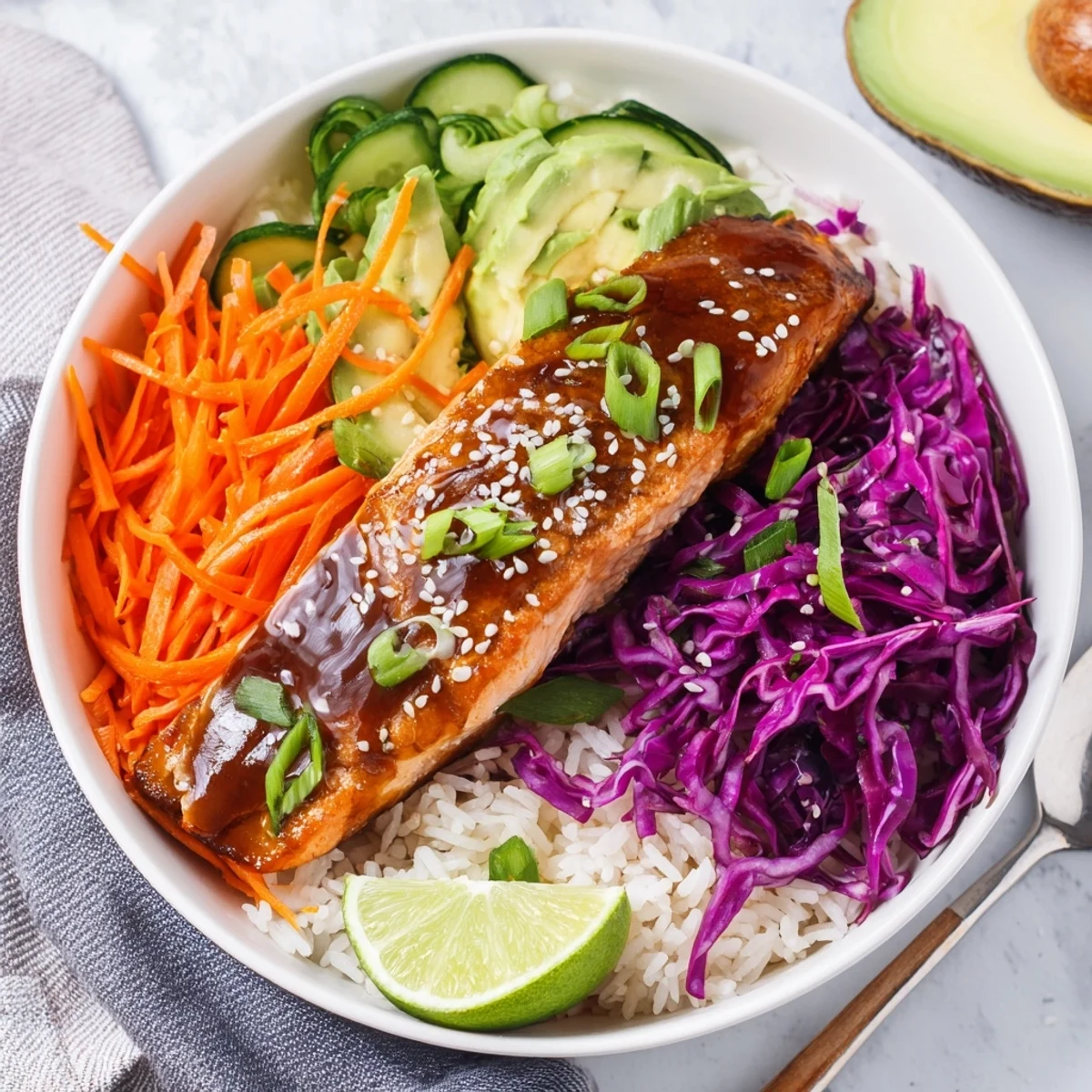 Easy homemade soy-maple salmon rice bowls with fresh avocado and crunchy cabbage.