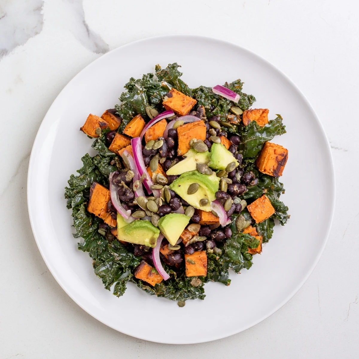 A colorful, hearty Massaged Kale Salad with roasted sweet potato, perfect for a healthy lunch.