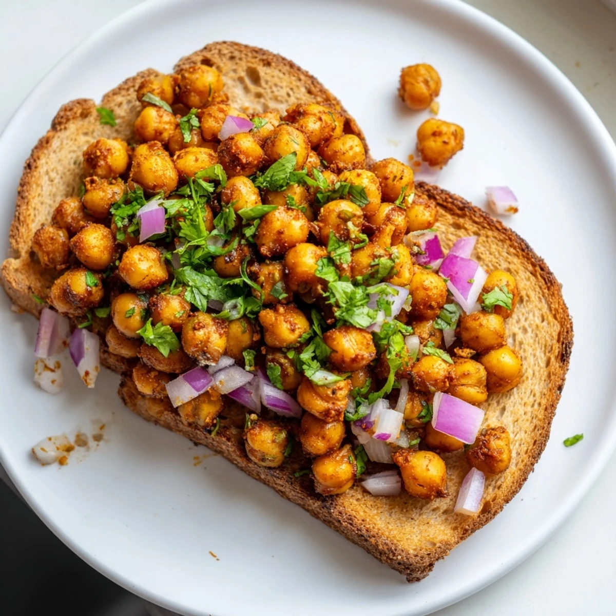 Smoky BBQ Chickpeas on Toast piled high with fresh cilantro, a delicious vegan lunch idea.