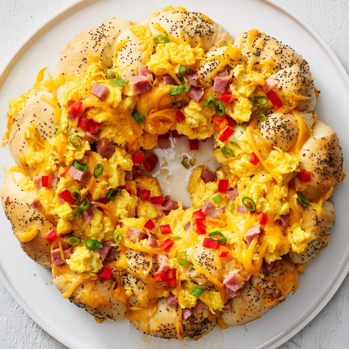 Wreath-Shaped Egg and Ham Bake, a golden-brown brunch dish filled with savory ham and cheese.