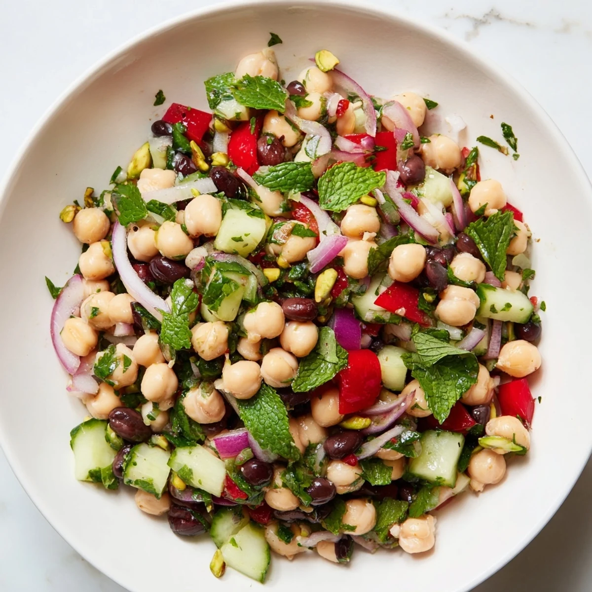 Refreshing view of the finished Dense Bean Salad with Dubai Chocolate Notes, drizzled with olive oil.