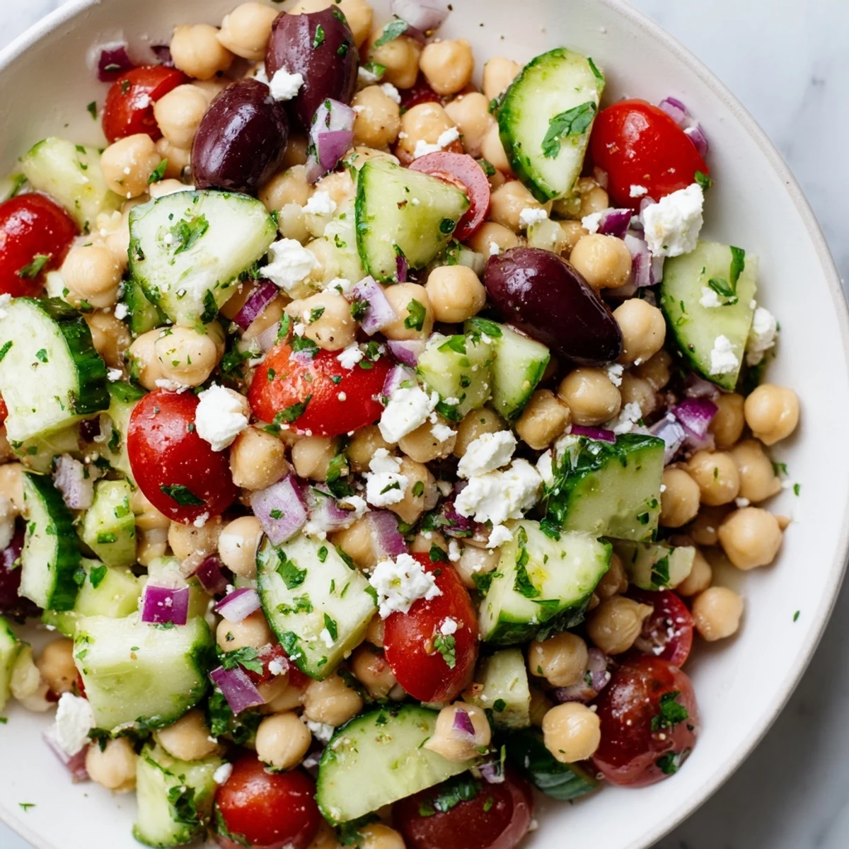 This delicious Mediterranean Chickpea Salad features tender chickpeas, crunchy vegetables, and a flavorful olive oil dressing.