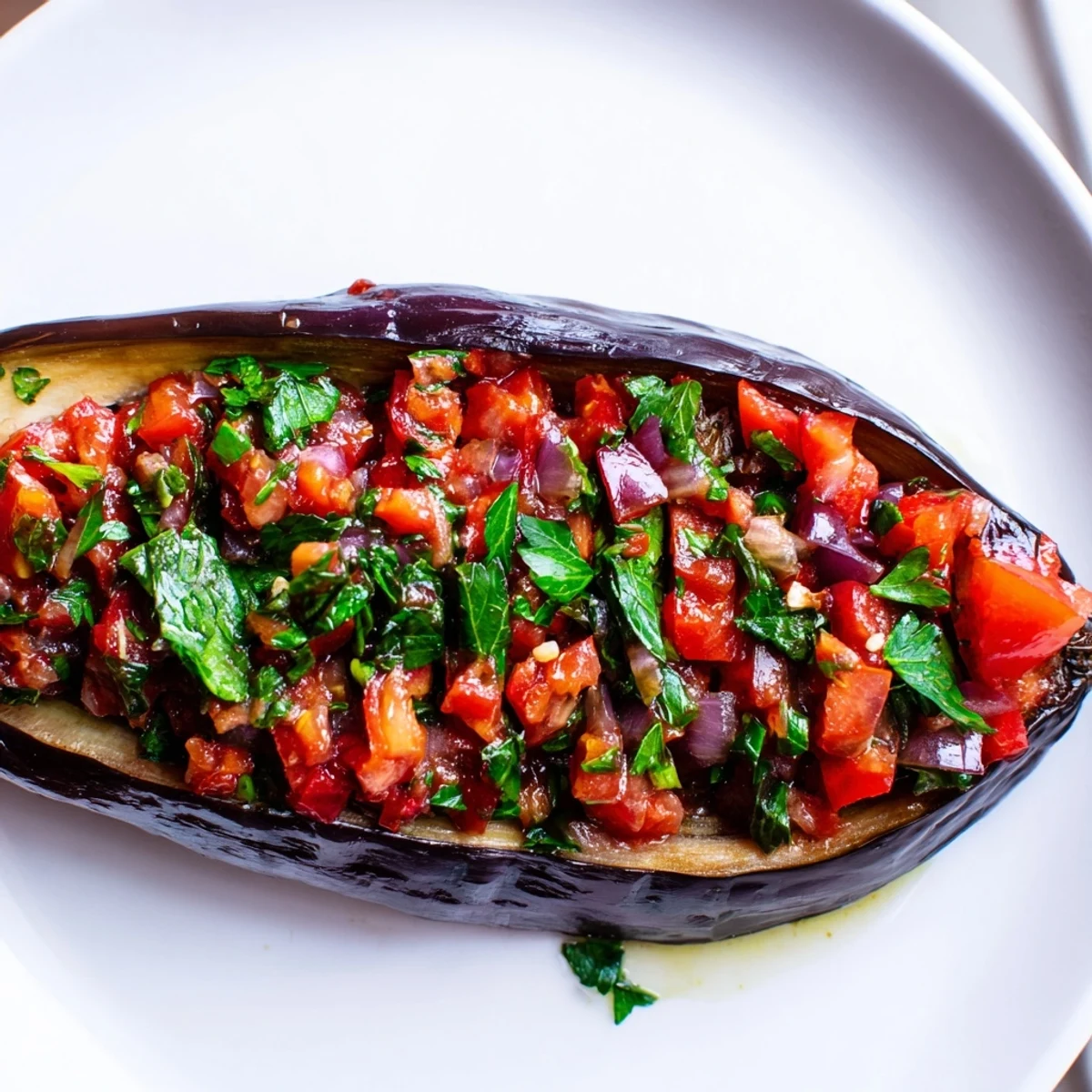Golden Imam Bayildi shows off tender eggplants overflowing with a rich tomato filling, ready to serve.