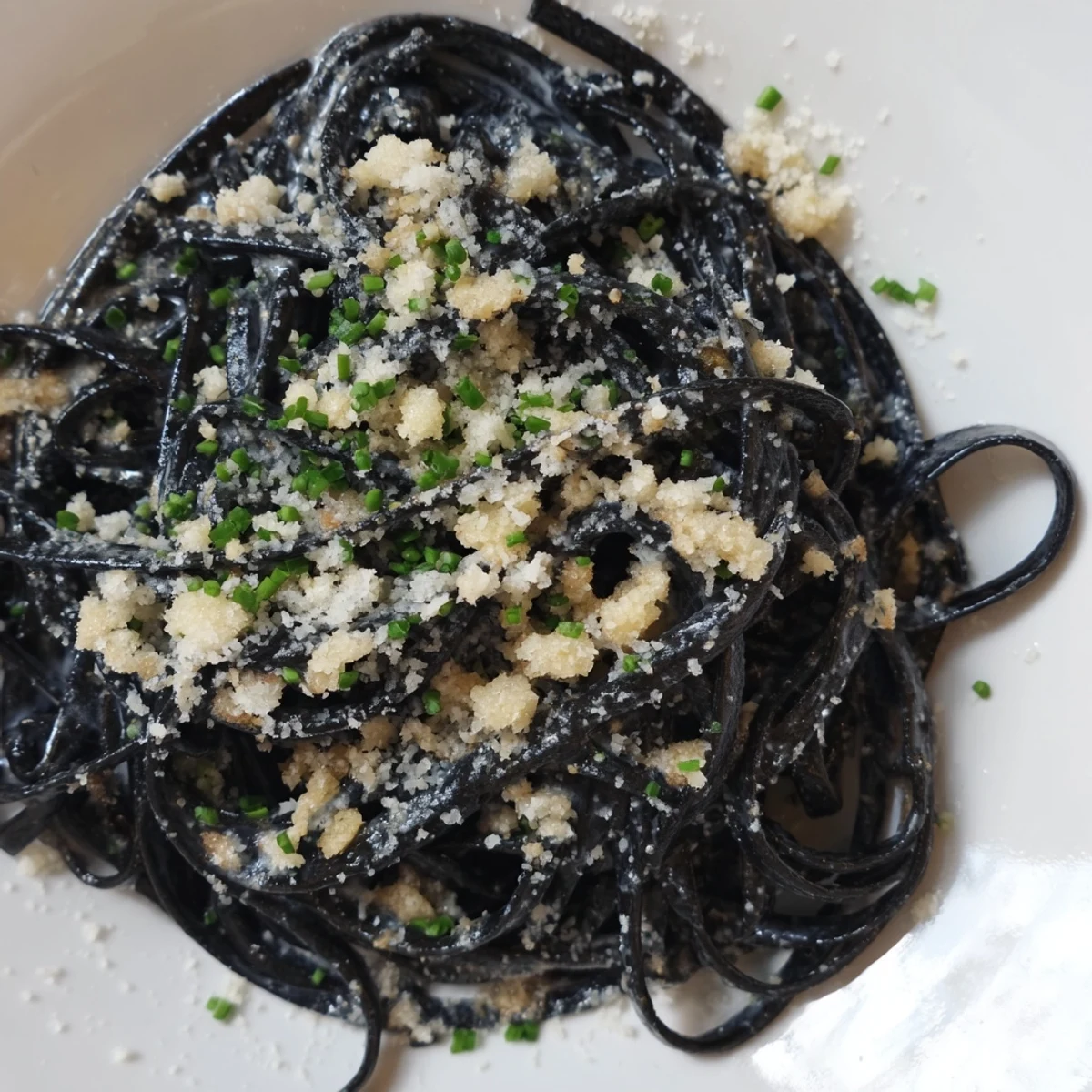 Silky, pitch-black Squid Ink Pasta twirls on a fork, ready for a taste of Italian luxury.