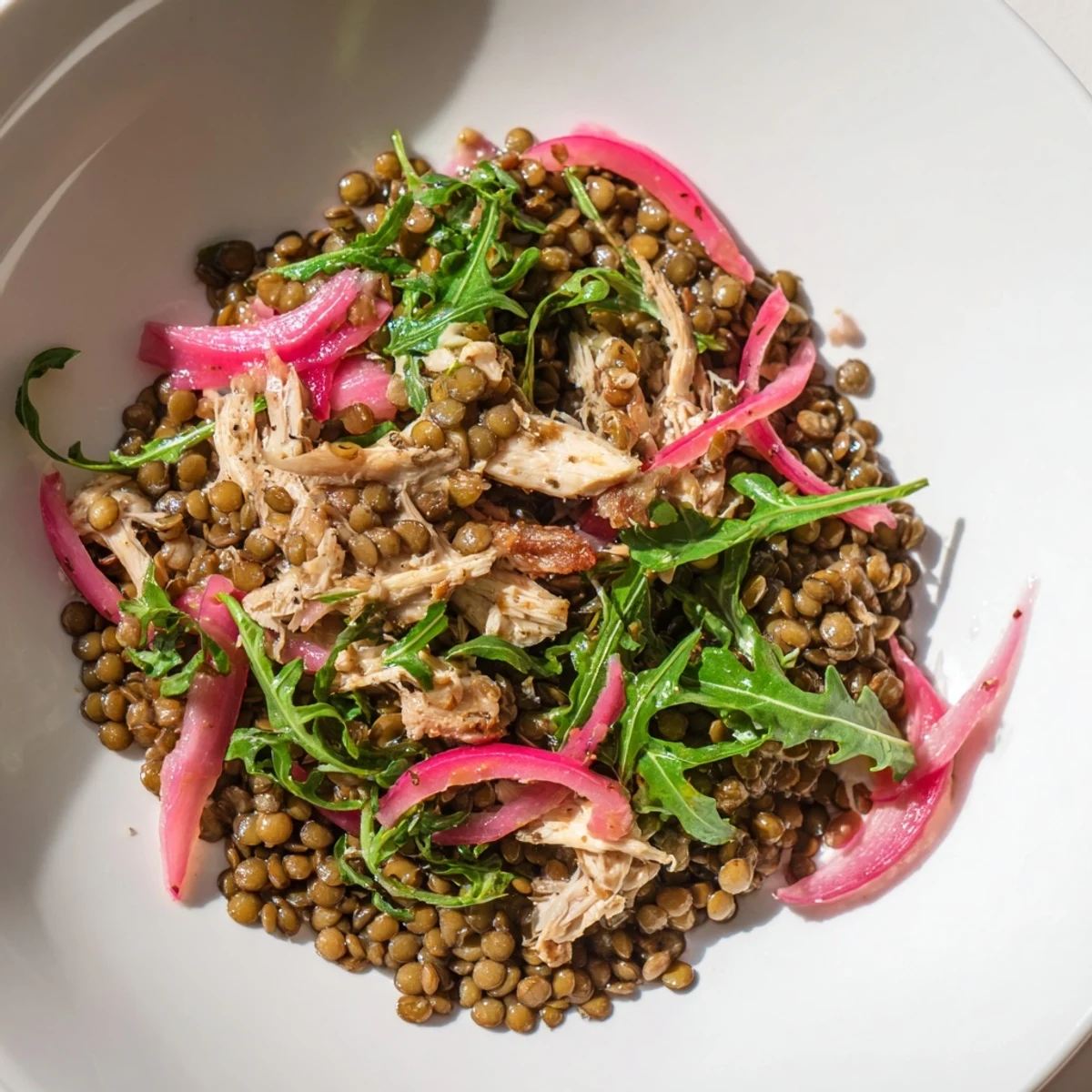 Freshly cooked green lentils and shredded roasted chicken tossed with peppery arugula and tangy pickled onions in a vibrant Lentil & Chicken Spring Salad.  