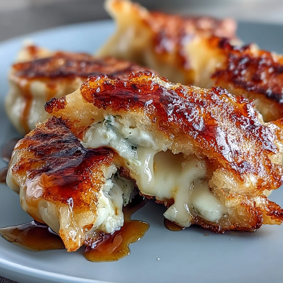 Golden-brown pan-fried Chīzu Imomochi dumplings glistening with sticky soy-honey glaze, served warm on a rustic wooden platter.  