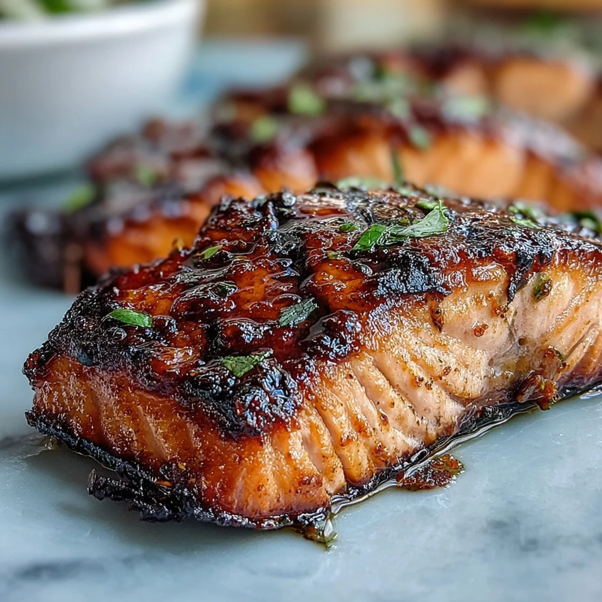 Wholesome grilled salmon over fluffy quinoa, topped with creamy avocado, fresh greens, and a tangy citrus dressing for a balanced meal.
