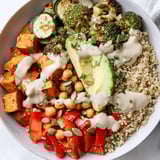Vibrant Quinoa Buddha Bowl with tender roasted vegetables, and a delicious tahini dressing, all perfectly balanced.