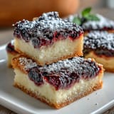 Golden shortbread base topped with bright blackberry lemon bar filling.