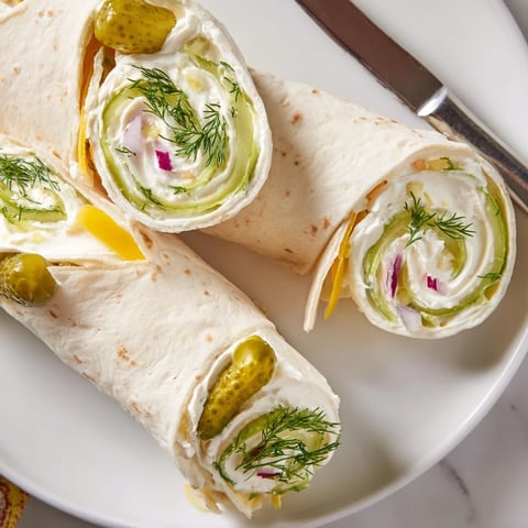 Crispy dill pickles wrapped in cheesy tortillas, perfect for your next party snack.  