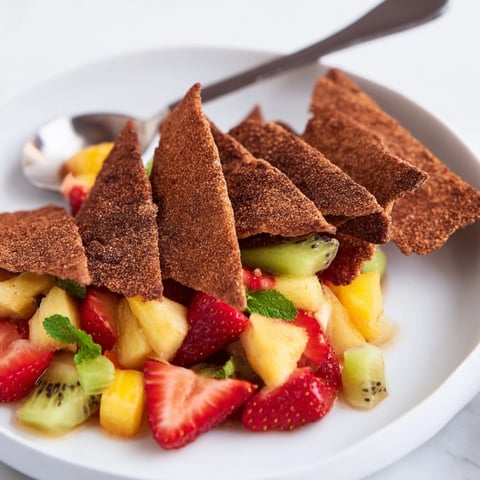 Crispy dessert chips & salsa served with colorful fruit blend for a festive twist.  