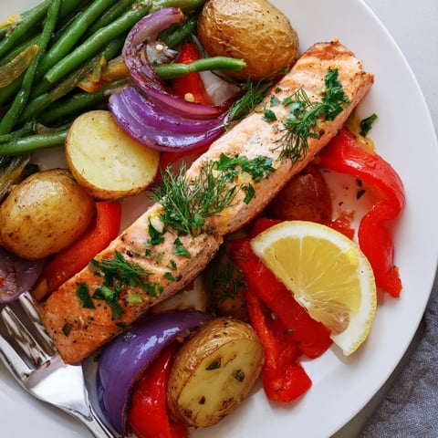 Lemon Herb Salmon & Potato Sheet Pan with roasted veggies and fresh herbs, perfect for dinner.