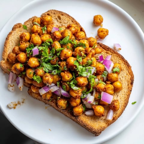Smoky BBQ Chickpeas on Toast piled high with fresh cilantro, a delicious vegan lunch idea.