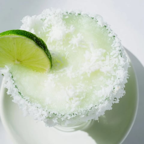 A vibrant White Christmas Margarita Slush, blended to a smooth, frosty texture for the holidays.