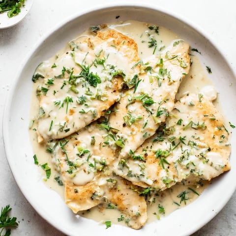 Golden-brown Lighter Creamy Tarragon Chicken, simmered in a creamy, herby sauce and ready to serve.