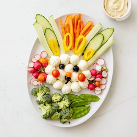 Colorful Easter Bunny Spring Platter starring fresh veggies, dips, and crackers, ideal for spring gatherings.