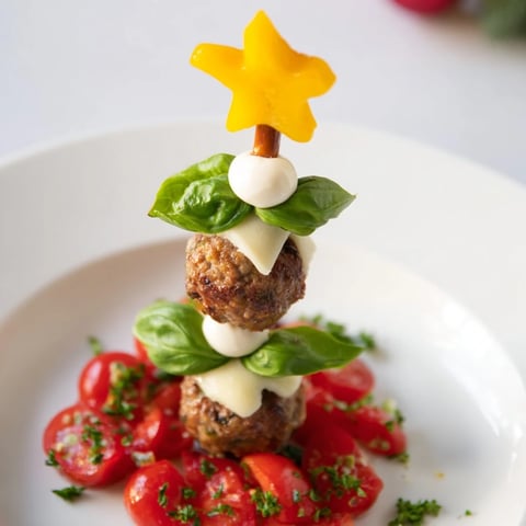Savory bites Christmas trees made with mini meatballs, tomato ornaments, and mozzarella.