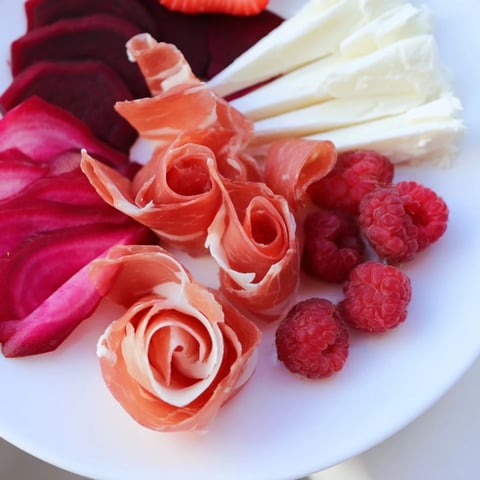 Pink Petal Watercolor Wash appetizer, a beautiful platter with pink cheese and vibrant fruit.