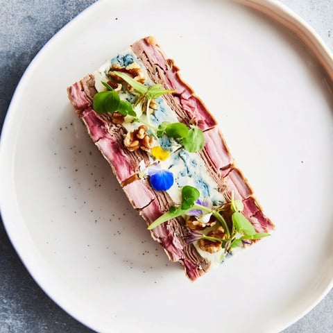 Vibrant slices of The Grand Canyon Rim meat terrine display the rich layered textures of the dish.