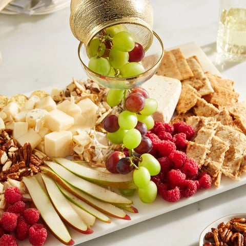 Champagne Waterfall Board overflowing with fruit and cheese, a beautiful centerpiece for entertaining.