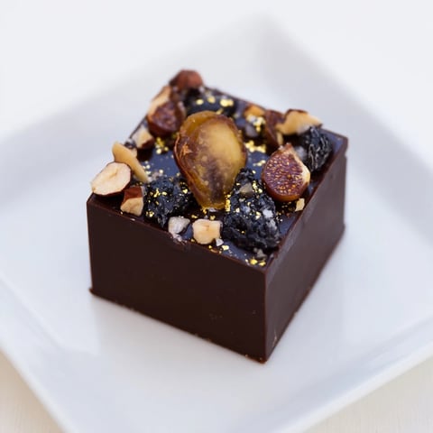 Decadent The Midnight Mosaic dessert with a mosaic of figs, olives, and rich dark chocolate.