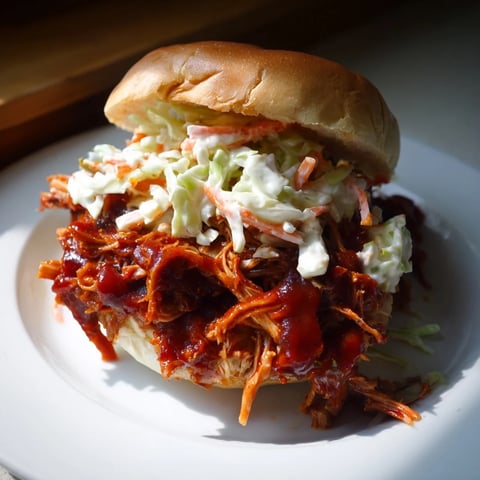 Tender BBQ jackfruit sliders on toasted buns, dripping with savory sauce and ready to devour.