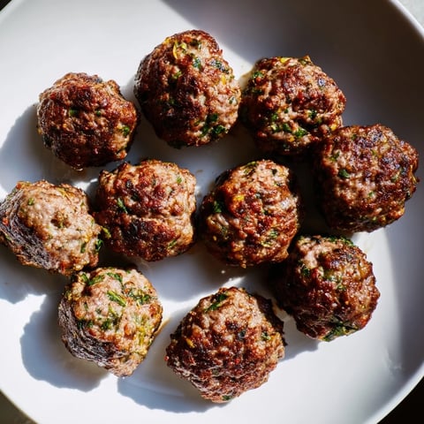 Golden-brown Turkish Köfte meatballs, pan-fried to perfection, are ready to be savored.