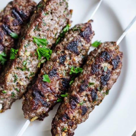 Smoky Iraqi Kebab Tikka skewers, grilled to perfection, offer a delicious, aromatic meat dish.