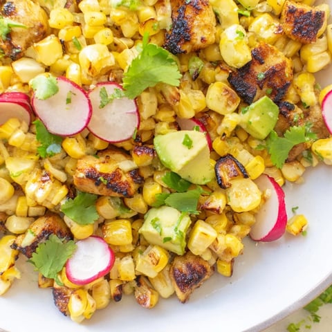 Tender grilled chicken and smoky roasted corn shine in this vibrant Roasted Corn & Chicken Chopped Salad with crisp radishes and creamy avocado.  