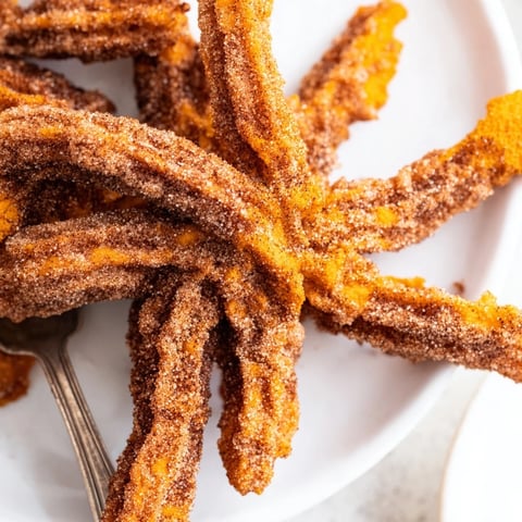 Soft and spiced Spicy Pumpkin Muffin Churros dusted with cinnamon sugar, ready to enjoy.  