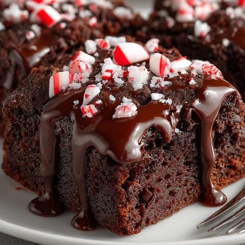 Fudgy Peppermint Mocha Brownies with a smooth chocolate glaze and festive peppermint candy topping.