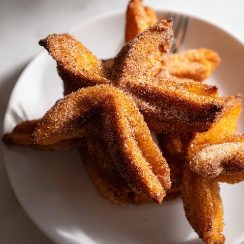 Golden-fried Spicy Pumpkin Muffin Churros served warm, perfect for cozy autumn gatherings.  
