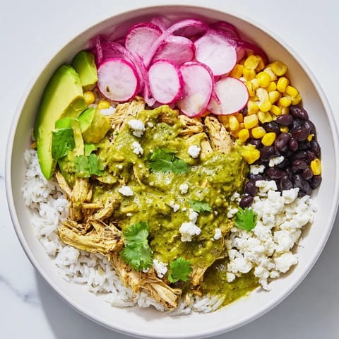 A close-up shot of the delicious Green Enchiladas Rice Bowl with avocado and cheese, ready to eat.