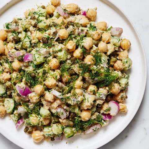 Freshly made chickpea tuna salad with crunchy celery and red onion, ready to eat.