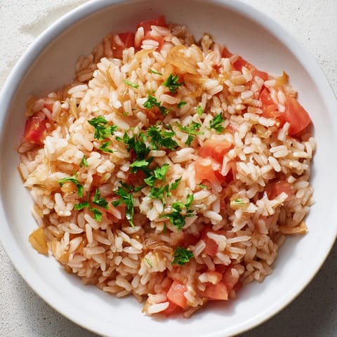 Close-up of a rustic Tomato-Rice Skillet Dinner, showcasing the vibrant colors and hearty texture.
