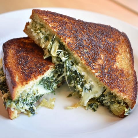 Crispy air fryer spinach & artichoke dip grilled cheese, a vegetarian sandwich bursting with creamy flavors.