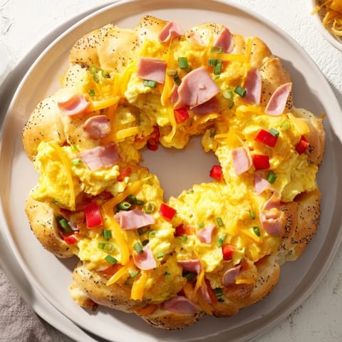Imagine a warm Wreath-Shaped Egg and Ham Bake, the perfect festive shareable breakfast, ready to eat.