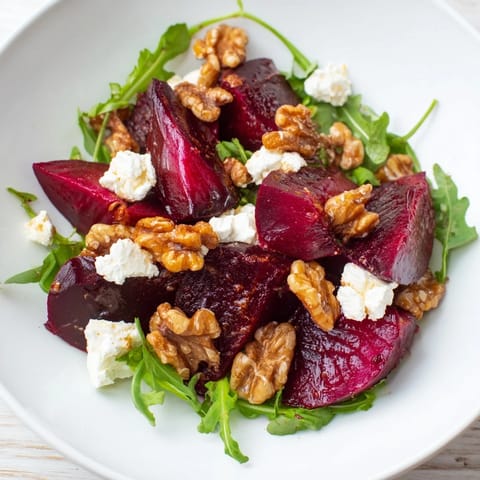 A colorful close-up of Roasted Beet Walnut Salad, showcasing sweet beets, creamy cheese, and crunchy walnuts.