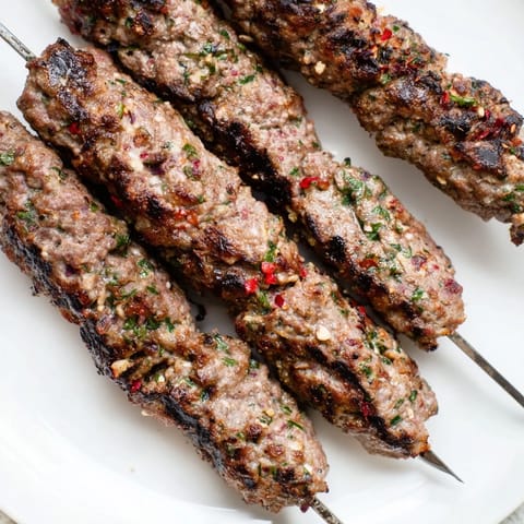 Close-up of succulent Iraqi Kebab Tikka: Charred edges hint at delicious, perfectly grilled ground meat kebabs.