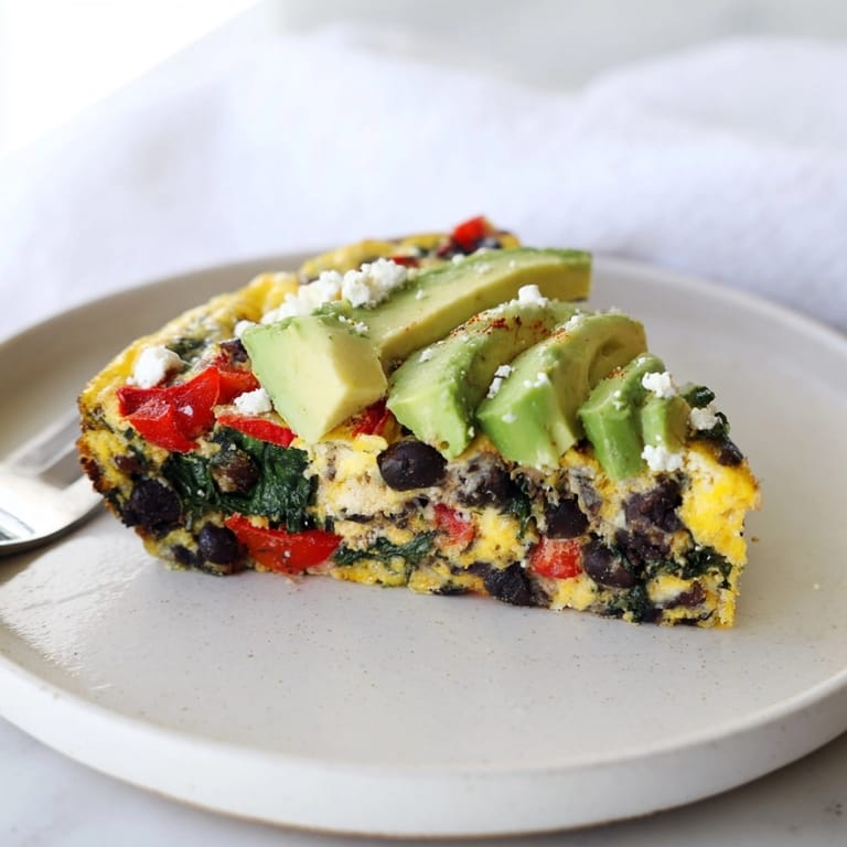 Imagine tasting the warm, cheesy Avocado Black Bean Egg Frittata, a satisfying Tex-Mex brunch.