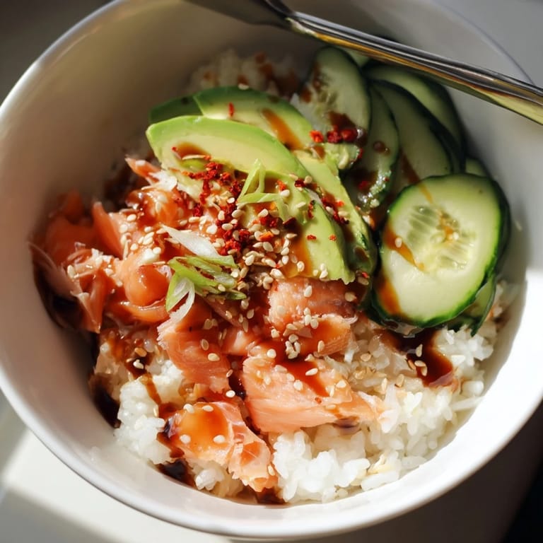 Delicious Leftover Salmon & Rice Bowl drizzled with soy sauce and sesame oil.  