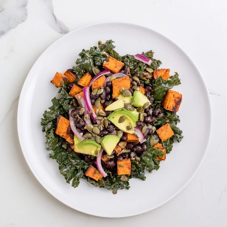 A colorful, hearty Massaged Kale Salad with roasted sweet potato, perfect for a healthy lunch.