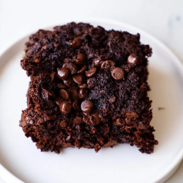 A plate of homemade Black Bean Brownies, moist and chocolatey, offering a delicious, healthy treat.