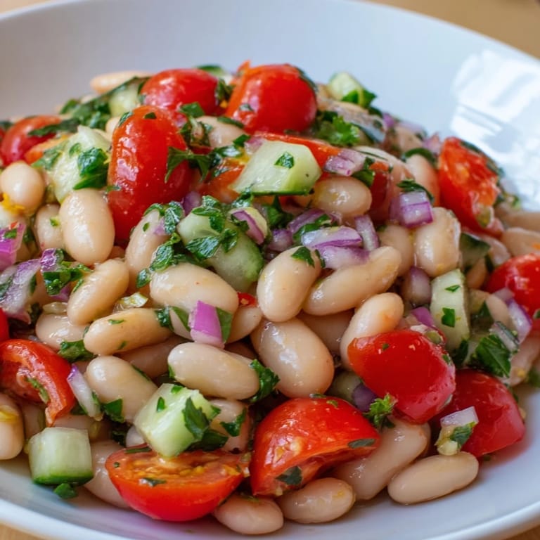 Hearty white bean salad featuring a medley of vegetables, perfect as a light, healthy meal.