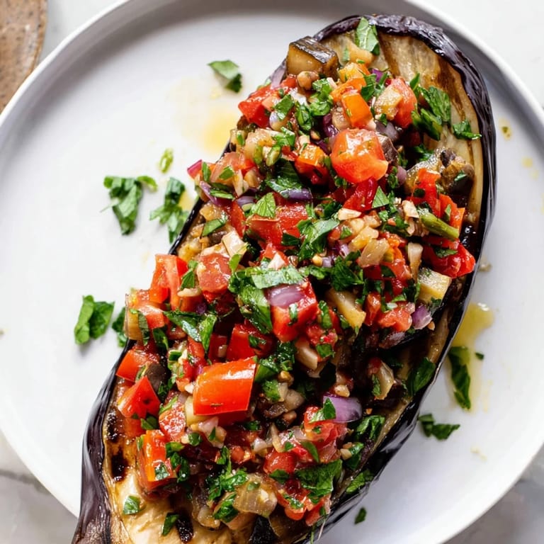 Perfectly baked Imam Bayildi, showcasing soft eggplant halves filled with savory tomato sauce and herbs.