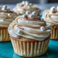 Soft vanilla Cancer birthday cupcakes adorned with shimmering pearl fondant toppers.